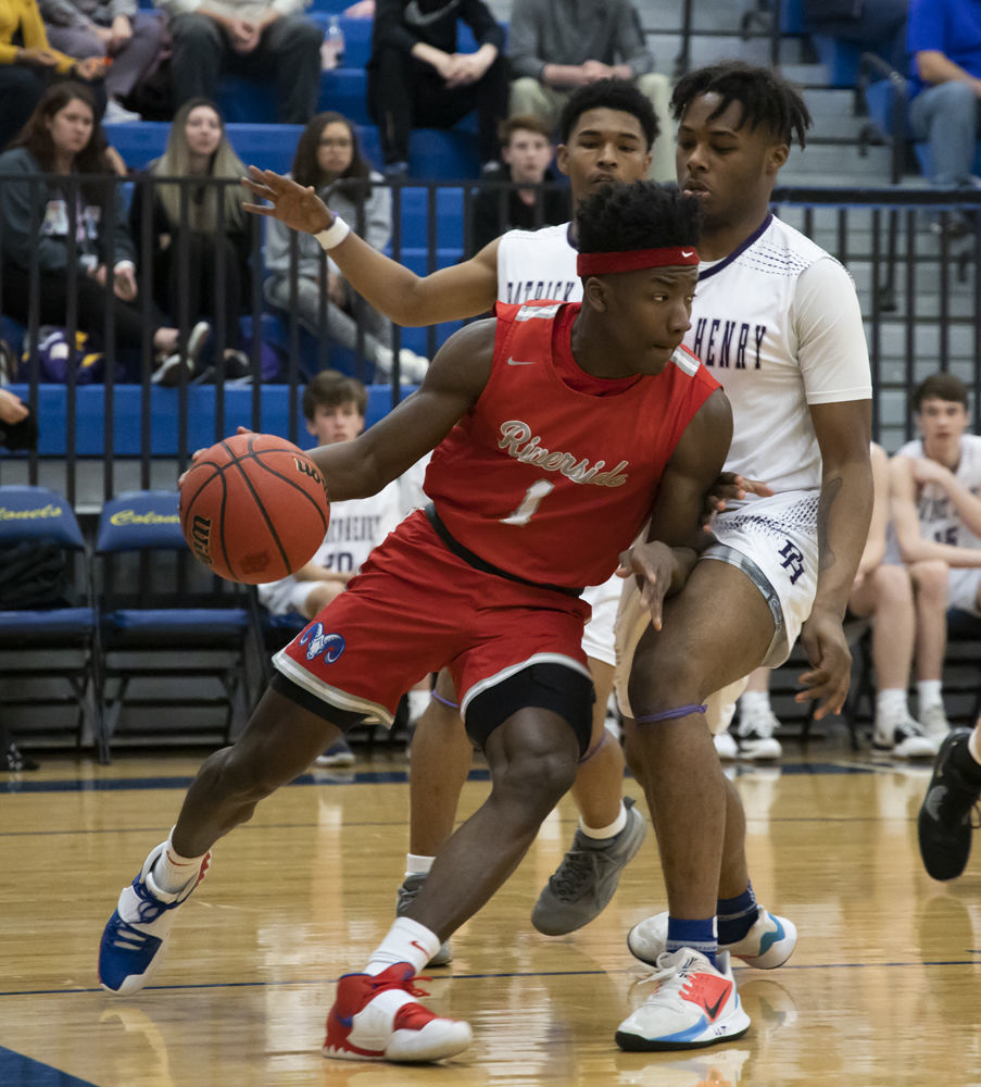 Riverside's Beau Everett (1) drives past Patrick Henry's Jalen Crump (5) as Jamontae Smith (1) trails the play.